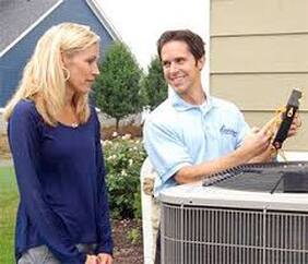 man fixing woman's air conditioner